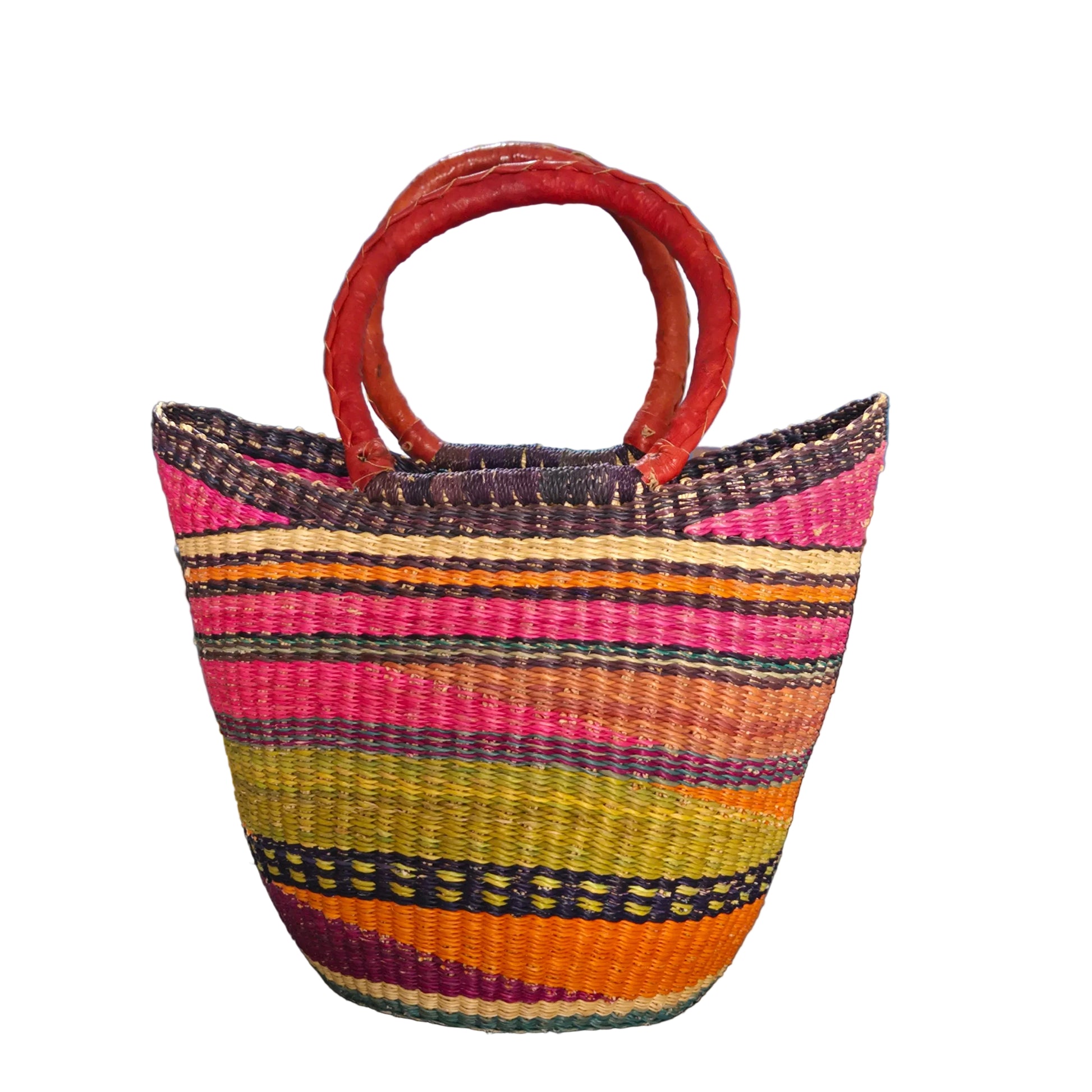 A hand-woven straw tote bag with vibrant multicolored vertical stripes in pink, orange, yellow, green, and purple, featuring two thick reddish-brown woven handles.
