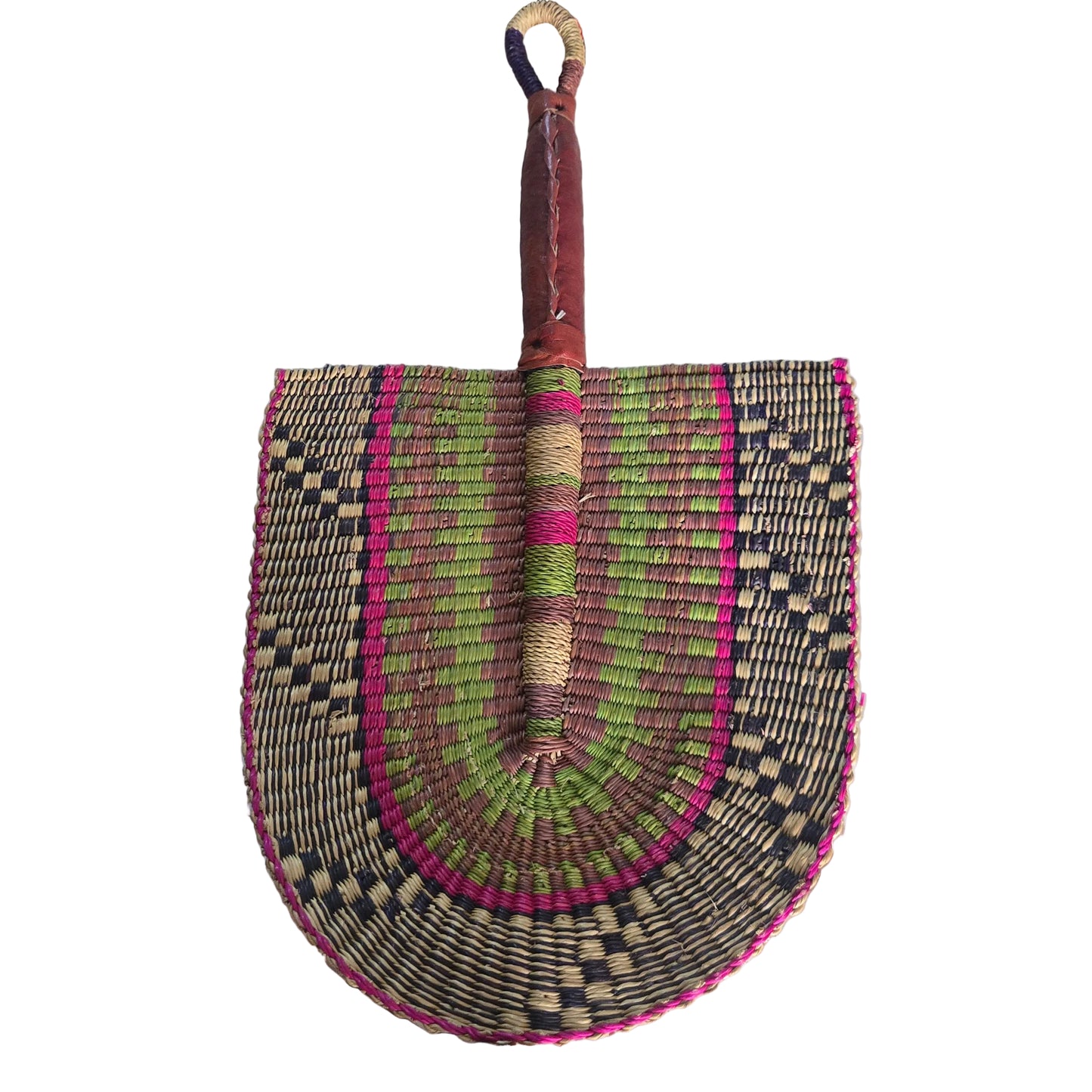 A hand-woven palm fan with a brown leather handle and a multicolored woven blade, resting on a white plastic tub in an indoor setting.