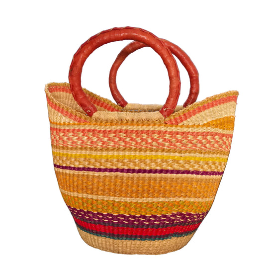 A woven straw tote bag with a striped pattern in yellow, orange, red, and green, featuring two thick reddish-brown handles.